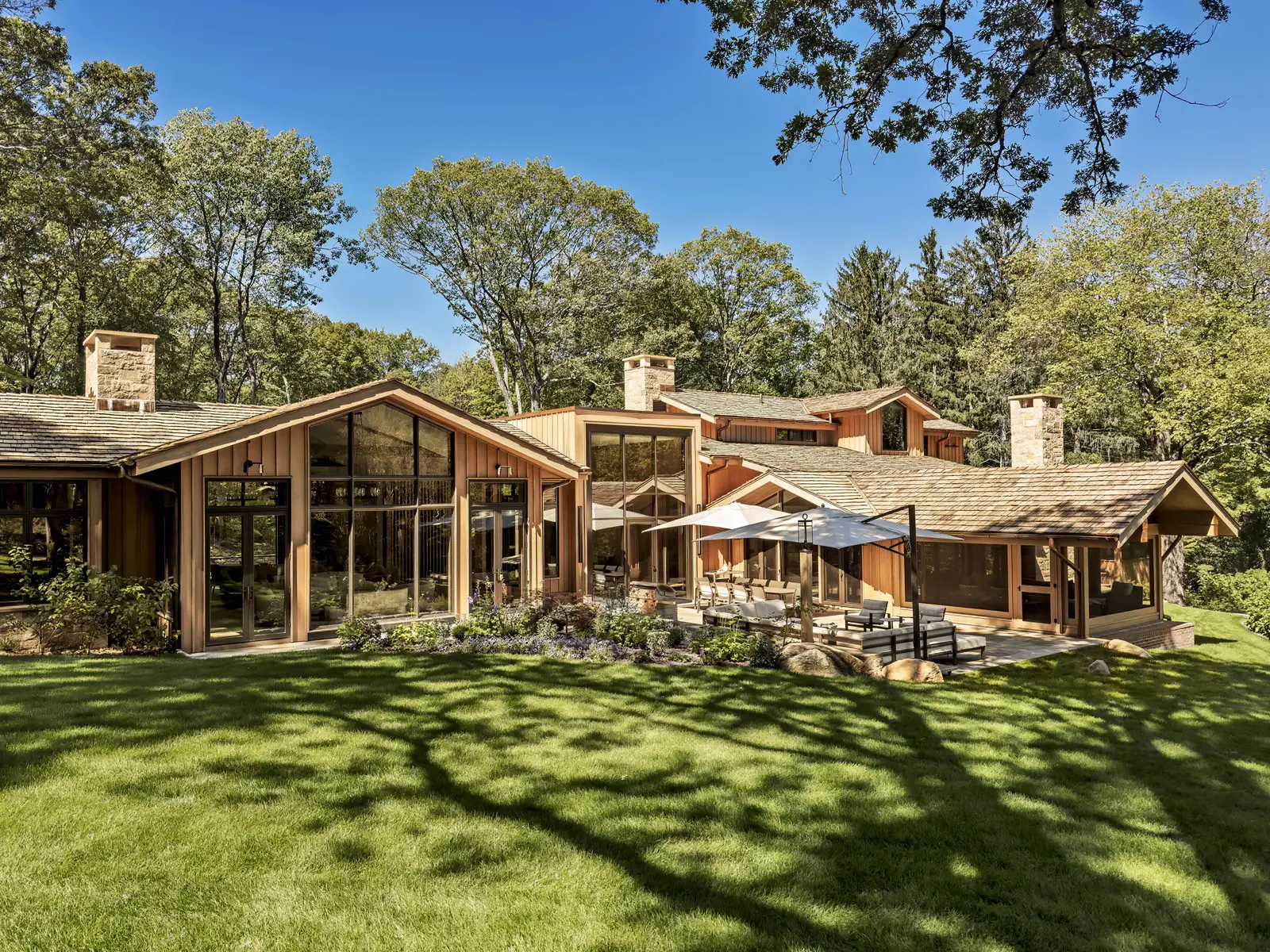Timber and glass home set in a wooded lawn
